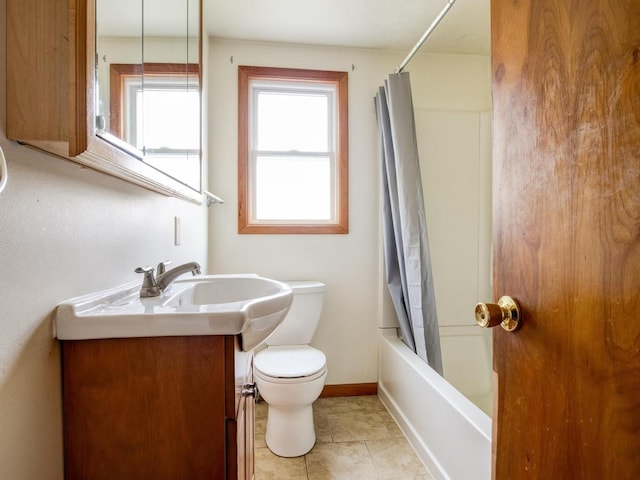 bathroom featuring tile patterned flooring, shower / tub combo with curtain, vanity, toilet, and baseboards