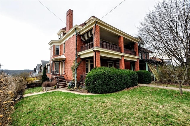 918 California Ave, Avalon, PA 15202 - rear view of property featuring brick siding, a yard, a balcony, and a chimney