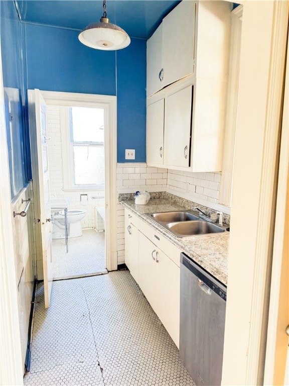 918 California Ave, Avalon, PA 15202 - kitchen featuring light countertops, white cabinetry, a sink, dishwasher, and hanging light fixtures