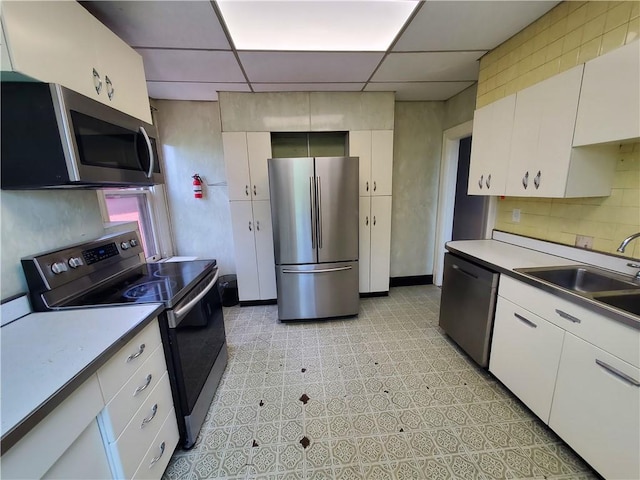 918 California Ave, Avalon, PA 15202 - kitchen with a sink, stainless steel appliances, white cabinetry, and a paneled ceiling