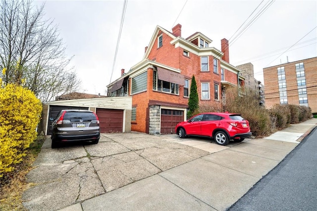 918 California Ave, Avalon, PA 15202 - view of front facade featuring brick siding, driveway, and a chimney