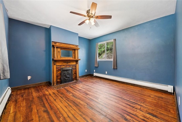 410 Main St, Dawson, PA 15428 - unfurnished living room featuring a baseboard radiator, a ceiling fan, hardwood / wood-style floors, and a fireplace