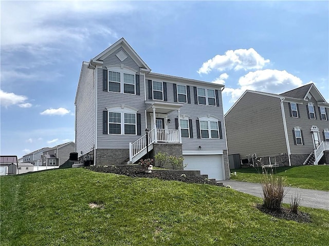 view of front of property with an attached garage, driveway, and a front yard