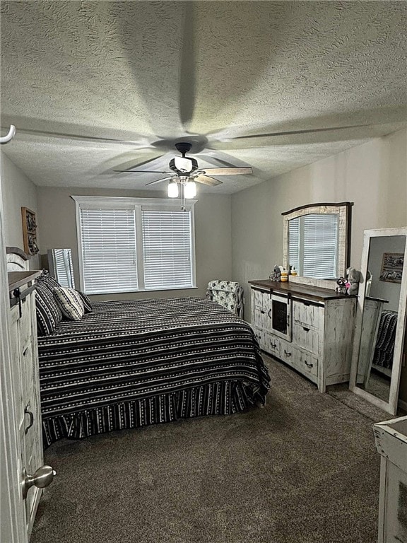 carpeted bedroom featuring a textured ceiling and ceiling fan