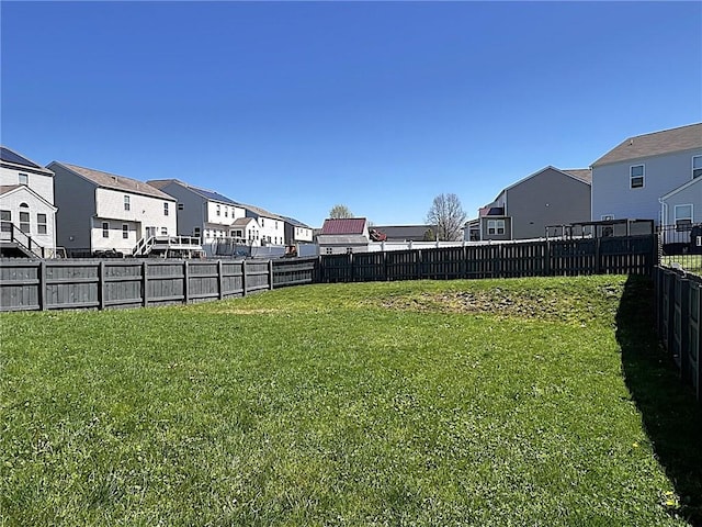 view of yard featuring a residential view and a fenced backyard