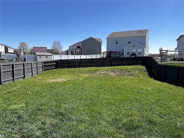 view of yard featuring a residential view and a fenced backyard