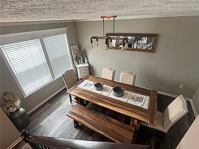 dining space featuring crown molding, baseboards, plenty of natural light, and wood finished floors