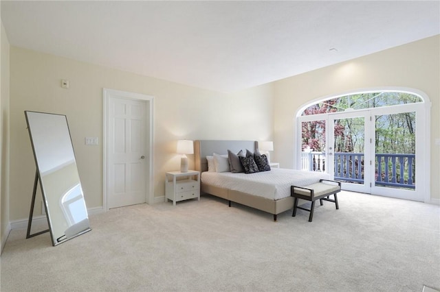 bedroom featuring access to outside, baseboards, and light carpet