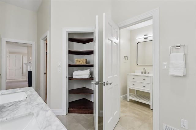 bathroom with vanity and baseboards