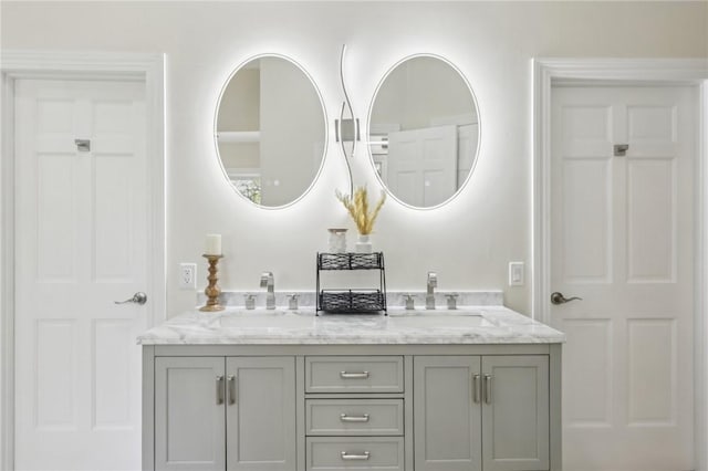 full bathroom with a sink and double vanity
