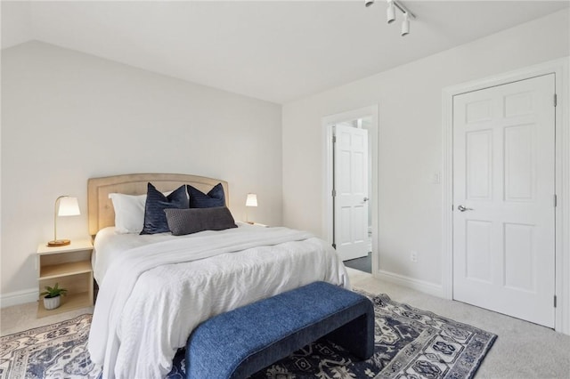 bedroom with baseboards and carpet