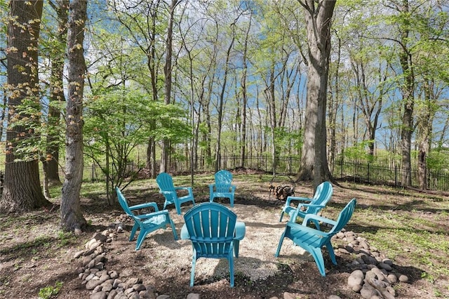 view of yard with fence and a fire pit