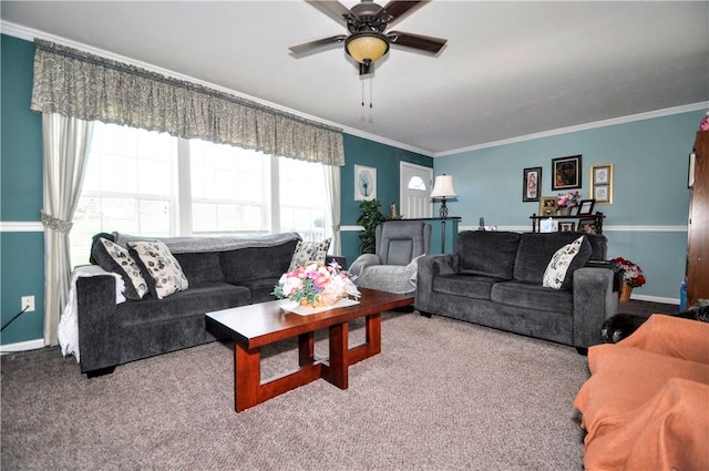 living room with ceiling fan, ornamental molding, baseboards, and carpet