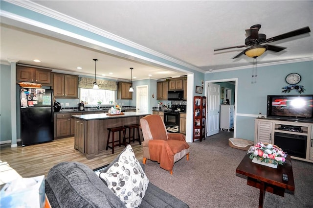 living area with recessed lighting, ceiling fan, ornamental molding, and baseboards