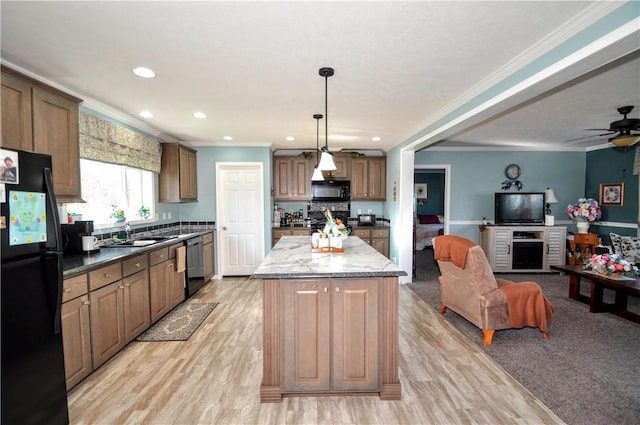 kitchen with crown molding, a kitchen island, open floor plan, recessed lighting, and black appliances