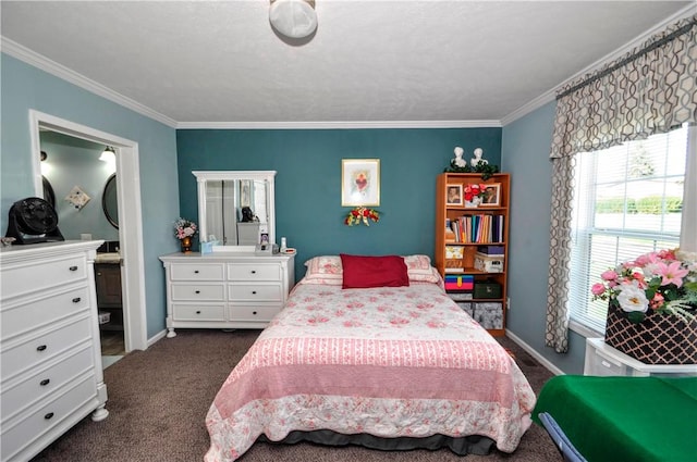 bedroom with crown molding, baseboards, ensuite bath, and dark colored carpet