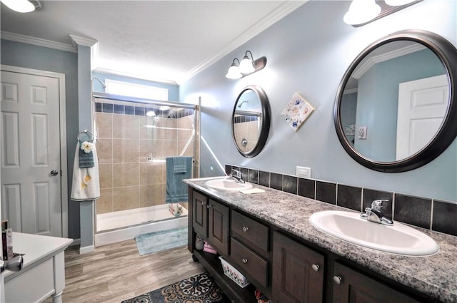 full bath featuring crown molding, a sink, and a stall shower