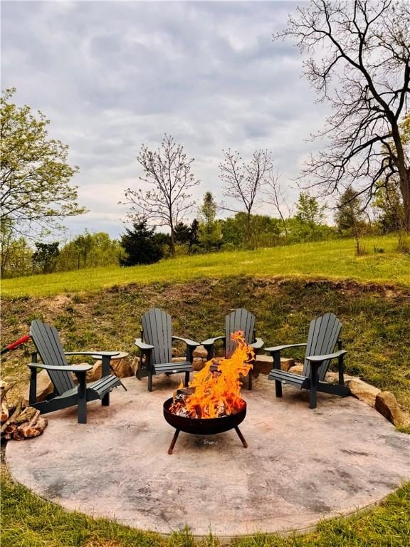 view of patio / terrace featuring an outdoor fire pit