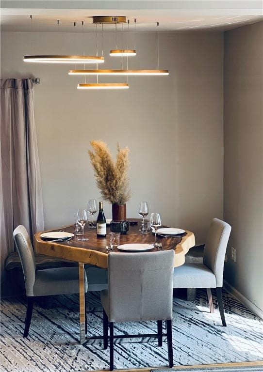 dining room featuring baseboards and wood finished floors