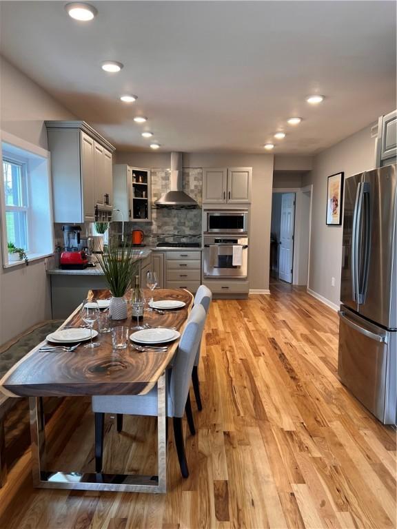 dining room featuring recessed lighting, baseboards, and light wood-type flooring