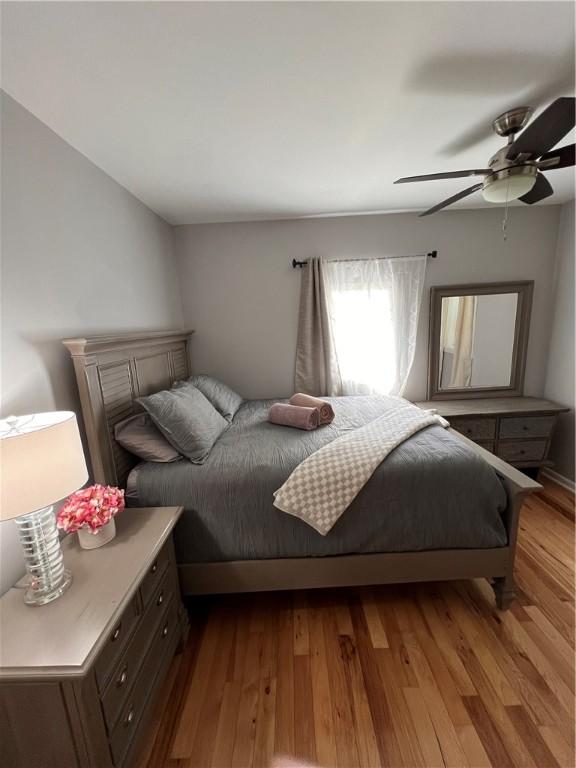 bedroom featuring a ceiling fan and wood finished floors