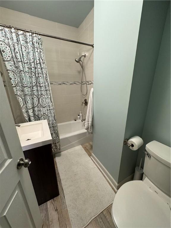190 Orchard Ln, Economy, PA 15042 - full bath featuring vanity, shower / tub combo with curtain, and wood finished floors