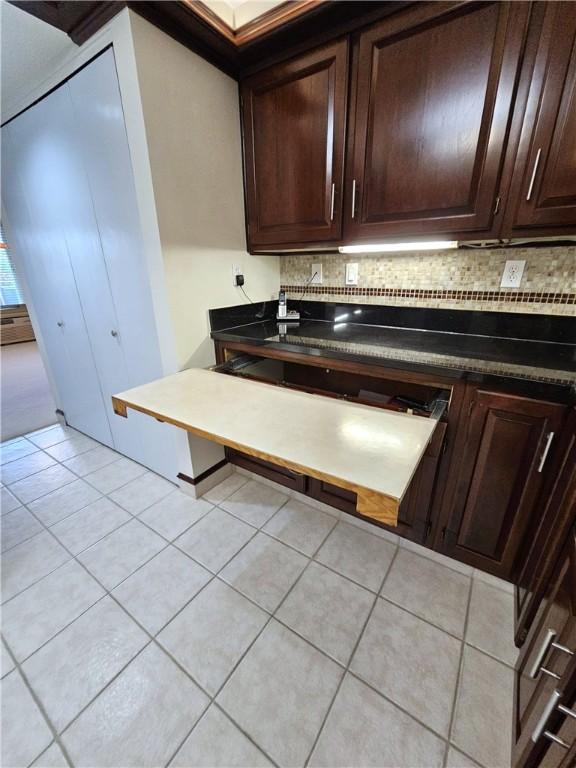 820 E Beau St Unit 2J, South Strabane, PA 15301 - kitchen with light tile patterned floors, decorative backsplash, and dark brown cabinetry