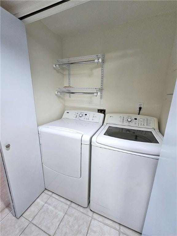 820 E Beau St Unit 2J, South Strabane, PA 15301 - laundry area featuring washing machine and clothes dryer, laundry area, and light tile patterned floors