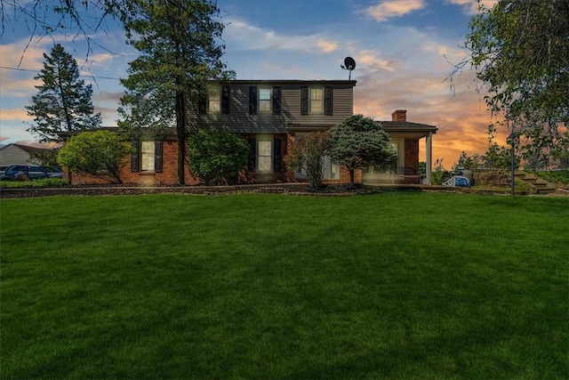 1202 Oakridge Rd, South Fayette, PA 15057 - view of front of home featuring a front lawn, a chimney, and brick siding