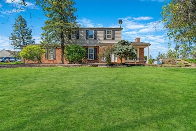 1202 Oakridge Rd, South Fayette, PA 15057 - view of front of house with a front lawn, a chimney, brick siding, and a porch