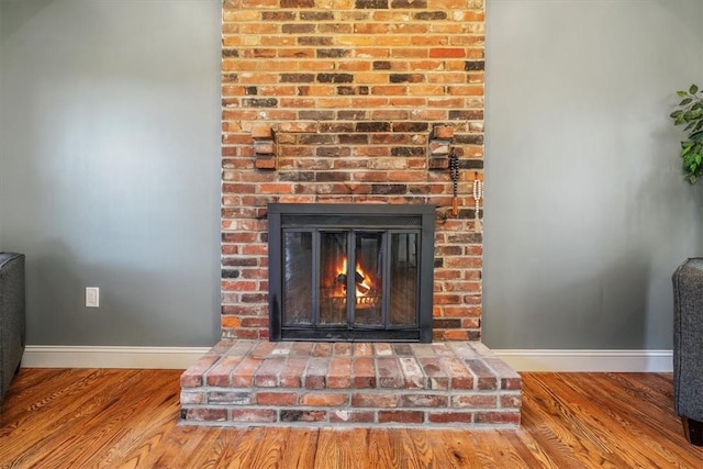 1202 Oakridge Rd, South Fayette, PA 15057 - detailed view of baseboards, wood finished floors, and a brick fireplace