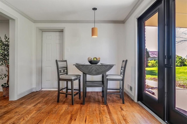 1202 Oakridge Rd, South Fayette, PA 15057 - dining room with ornamental molding, light wood-type flooring, and baseboards