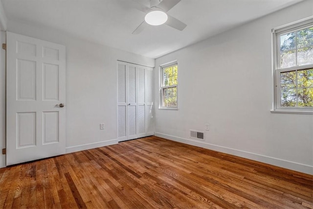 1202 Oakridge Rd, South Fayette, PA 15057 - unfurnished bedroom with multiple windows, baseboards, wood finished floors, and a closet