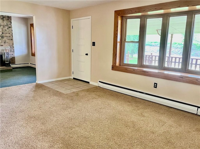entryway with light tile patterned flooring, light carpet, baseboards, baseboard heating, and a baseboard radiator