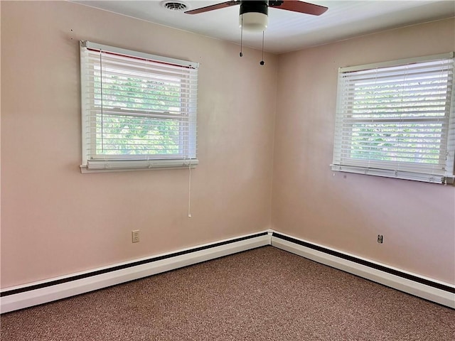 spare room with plenty of natural light, carpet, ceiling fan, and baseboard heating