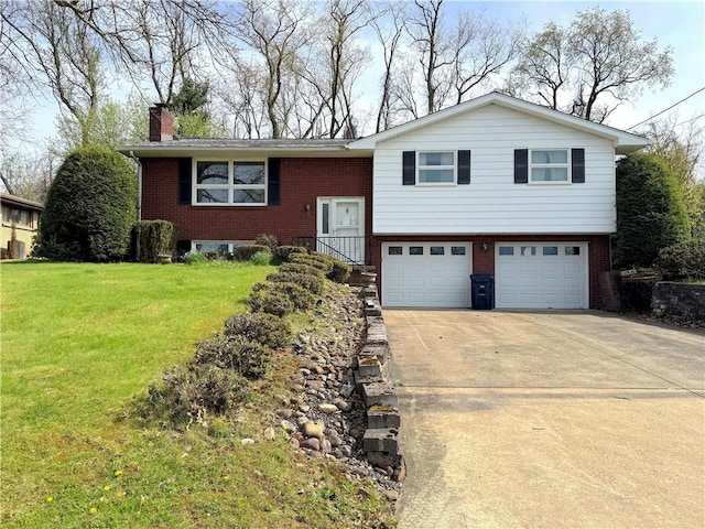 bi-level home with brick siding, an attached garage, a front yard, and a chimney