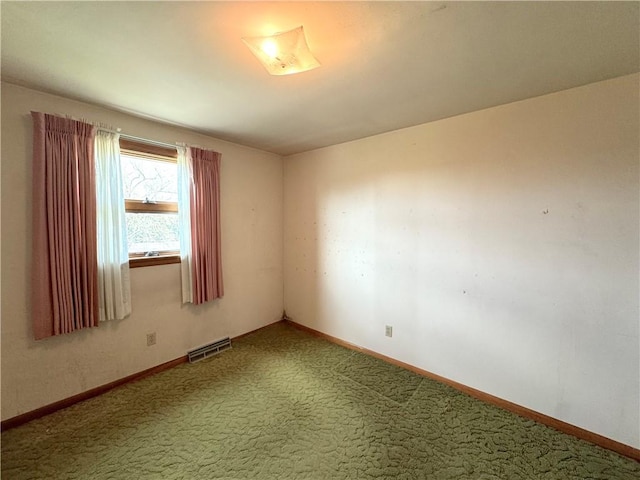 carpeted empty room featuring baseboards and visible vents