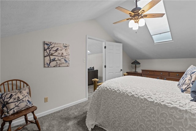 bedroom featuring baseboards, ceiling fan, carpet, and lofted ceiling with skylight