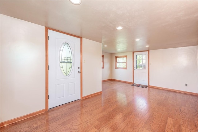 foyer featuring recessed lighting, baseboards, and light wood-style flooring