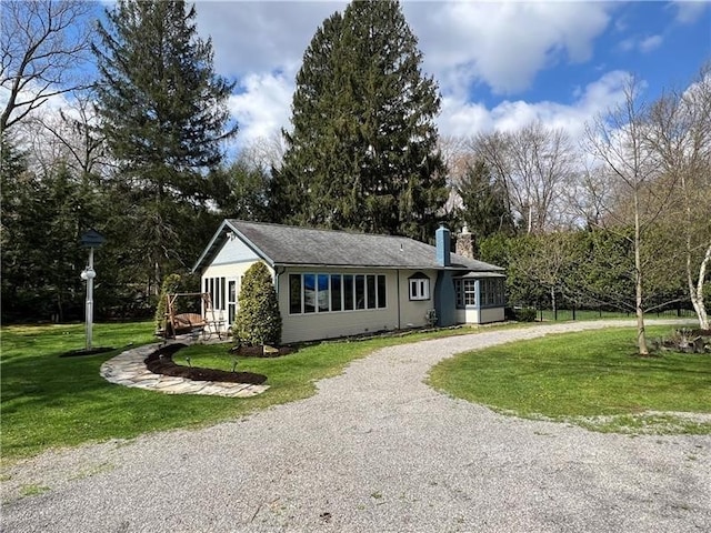 171 Mohawk Trl, Slippery Rock Twp But, PA 16057 - view of front of home with curved driveway, a chimney, and a front lawn