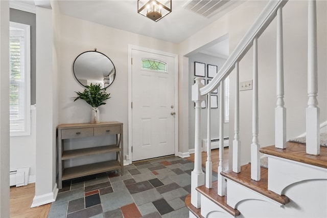 entrance foyer with baseboards, a baseboard radiator, stairs, and visible vents