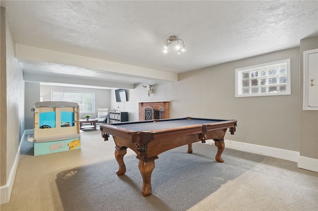 playroom featuring a fireplace, baseboards, a textured ceiling, pool table, and carpet flooring