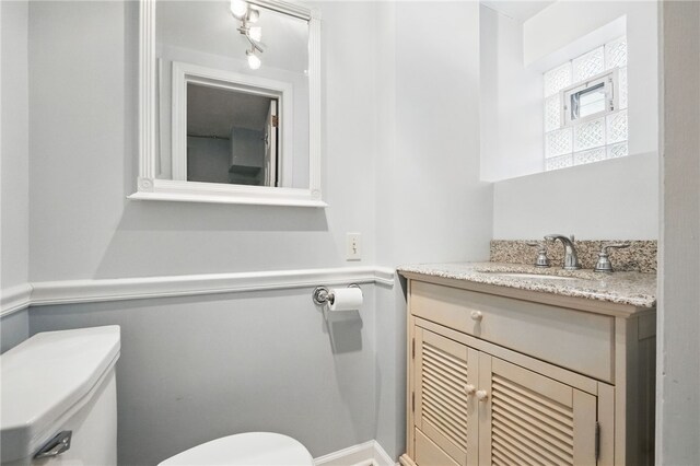 bathroom with vanity and toilet