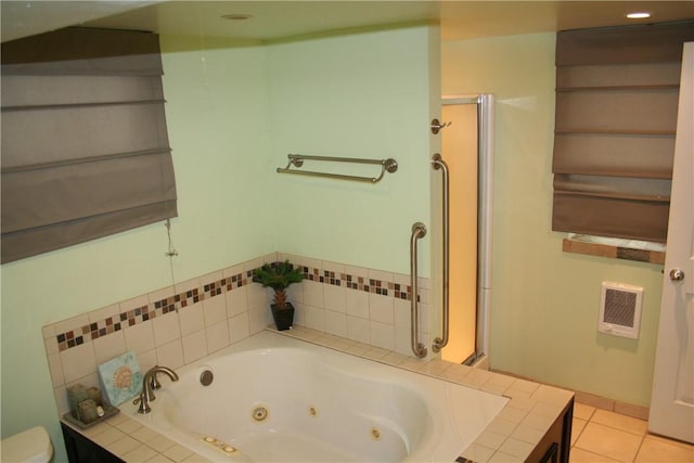full bath featuring tile patterned floors, a whirlpool tub, and toilet