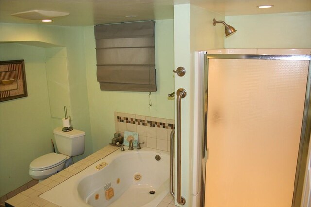 full bathroom featuring a jetted tub and toilet