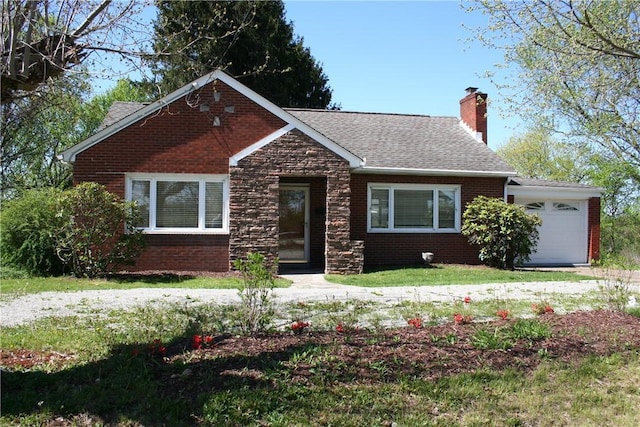 view of front of home featuring brick siding, a shingled roof, an attached garage, and a chimney