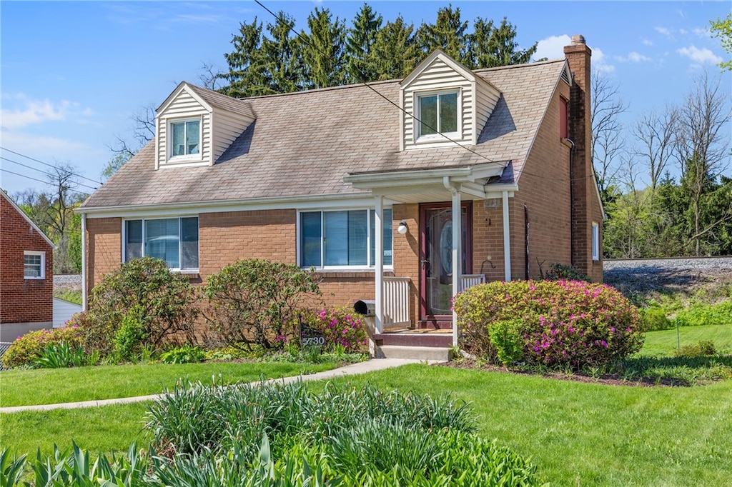 5730 Janet Dr, Bethel Park, PA 15236 - cape cod home with brick siding, a chimney, and a front lawn