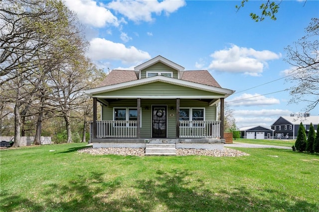 bungalow-style home featuring a porch, a shingled roof, and a front lawn