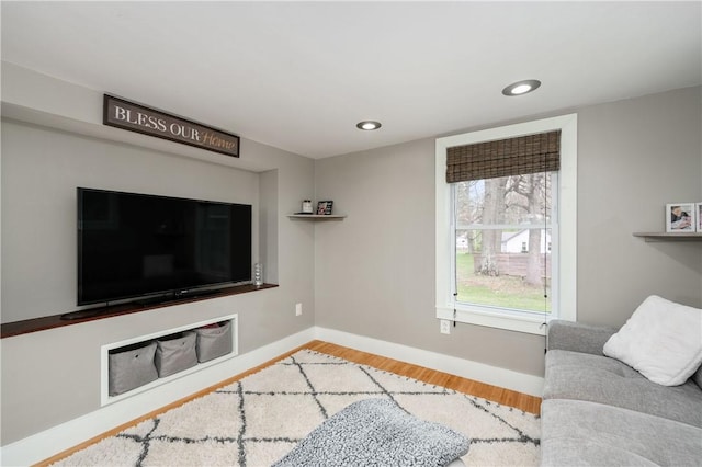 living room featuring baseboards, recessed lighting, and wood finished floors