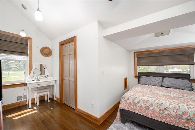 bedroom with baseboards, visible vents, dark wood-type flooring, and lofted ceiling
